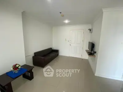 Spacious living room with modern decor and sleek furniture in a contemporary apartment.