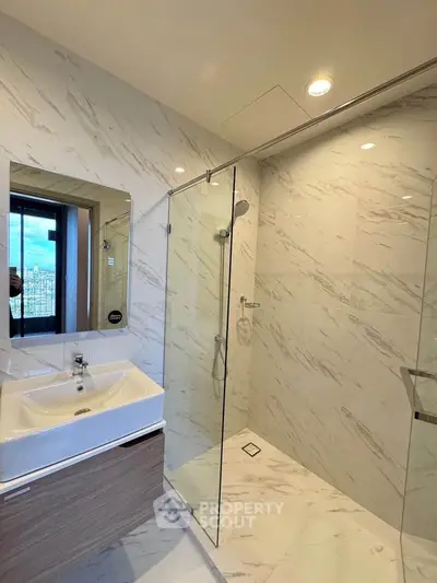 Modern bathroom with glass shower and elegant marble tiles