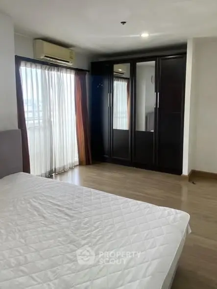 Spacious bedroom with large wardrobe and natural light