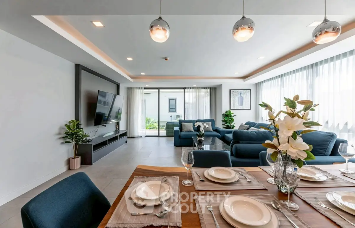 Luxurious open-plan living room with elegant dining area and modern decor