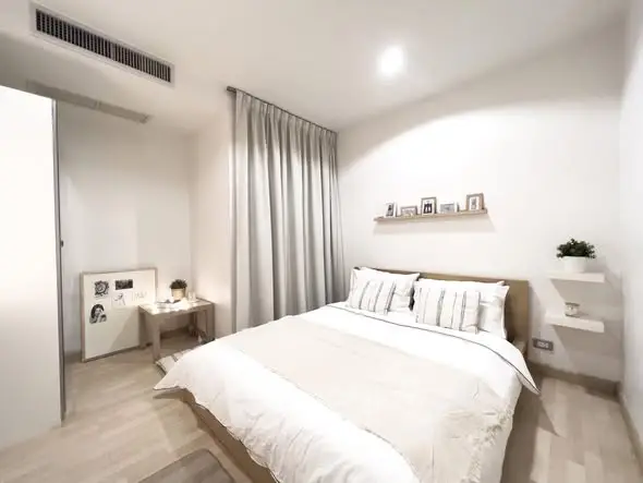 Modern minimalist bedroom with cozy decor and soft lighting