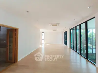 Spacious modern interior with large windows and wooden flooring