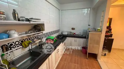 Spacious kitchen with modern design and ample storage in a cozy home setting.
