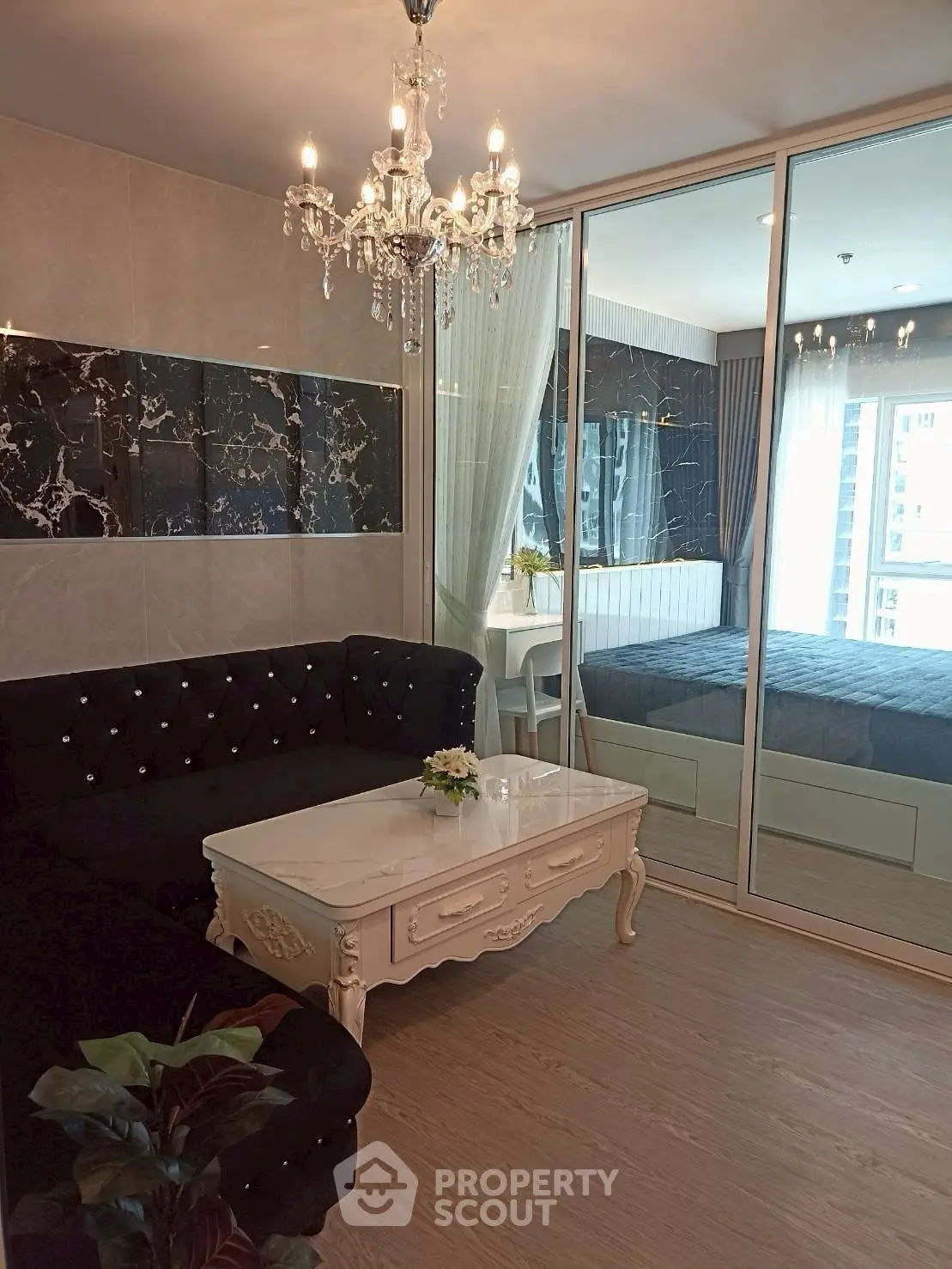 Luxurious living room with elegant chandelier and stylish decor in modern apartment