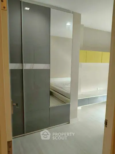 Modern bedroom with sleek wardrobe and minimalist design