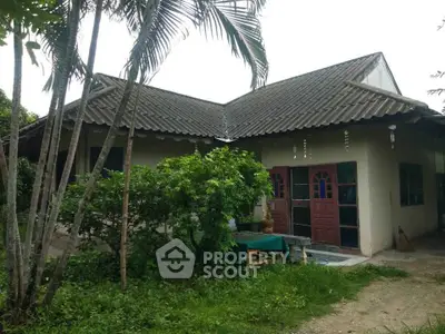 Charming rustic house with lush greenery and traditional roof design, perfect for nature lovers seeking tranquility.