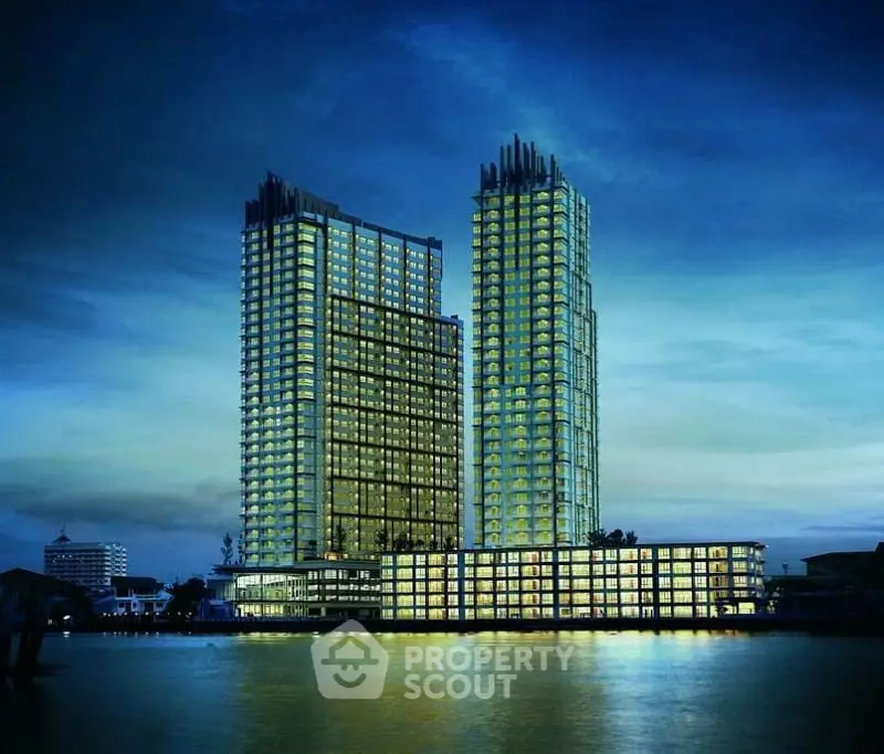 Stunning waterfront twin towers with modern architecture and illuminated windows at dusk.