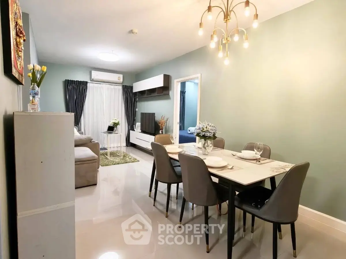Elegant living and dining area with modern decor and stylish lighting