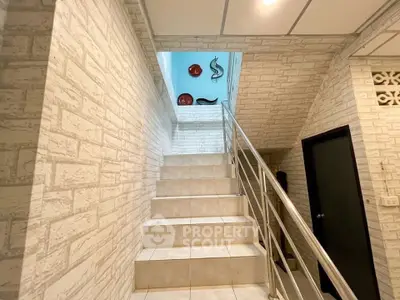 Stylish staircase with modern decor in a well-lit interior space