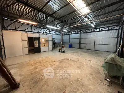 Spacious industrial warehouse with high ceilings and ample storage space.