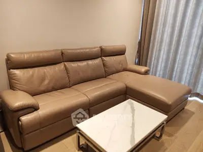 Luxurious leather sofa in modern living room with elegant marble coffee table.