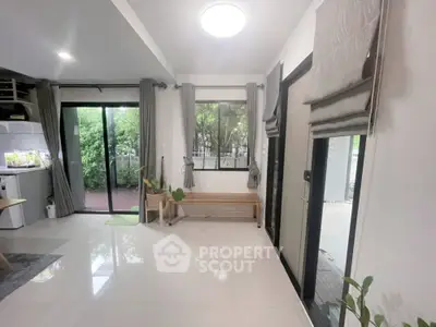 Bright modern living room with large windows and garden view