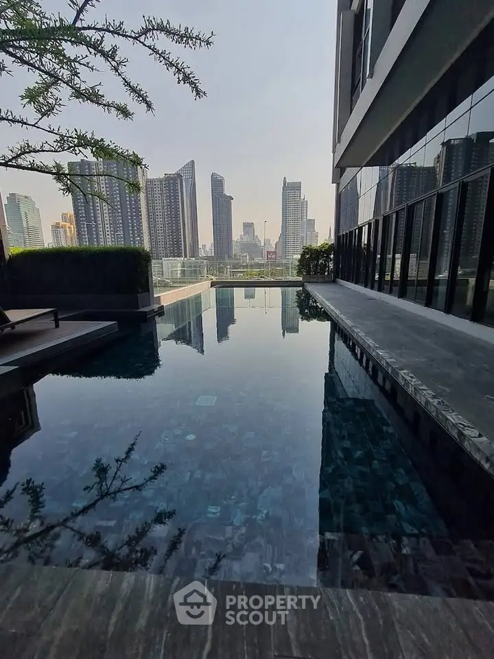 Luxurious rooftop pool with stunning city skyline view in modern high-rise building.