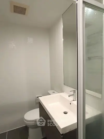Modern bathroom with sleek fixtures and glass shower enclosure