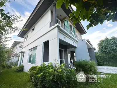 Modern two-story house with lush garden and spacious balcony