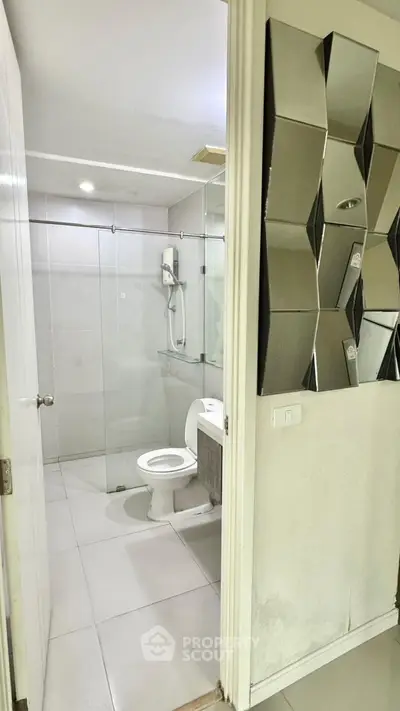 Modern bathroom with glass shower and unique wall mirror design