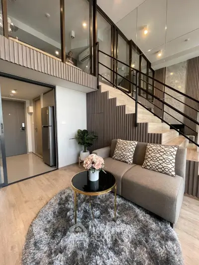 Modern duplex living room with stylish decor and elegant staircase