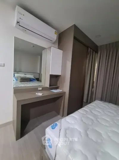 Modern bedroom with air conditioning and stylish furniture, perfect for comfort and relaxation.