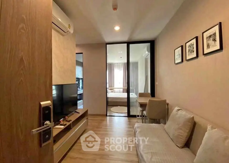 Modern living room with wooden flooring and stylish decor in a cozy apartment.