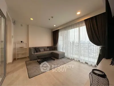 Spacious living room with city view and elegant curtains