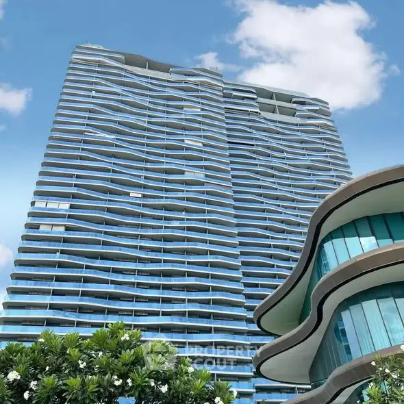 Stunning modern high-rise building with unique architectural design and lush greenery.