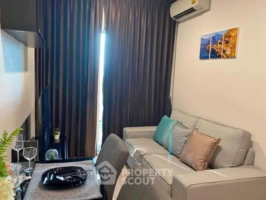 Cozy living room with modern decor and air conditioning, perfect for relaxation.