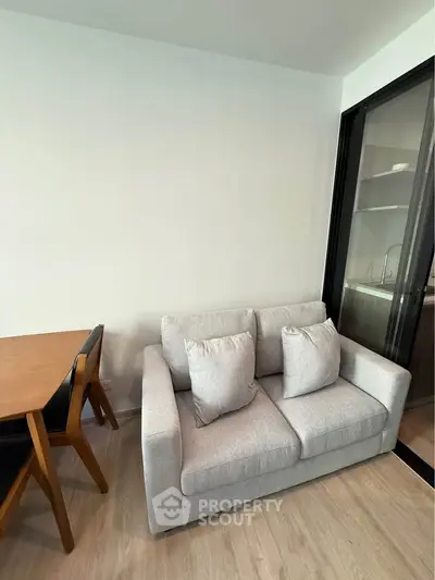 Modern living room with cozy sofa and dining table in stylish apartment