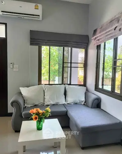 Cozy living room with modern sofa and vibrant floral decor