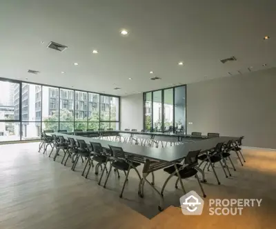 Spacious modern conference room with large windows and natural light