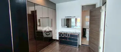 Modern bedroom with sleek mirrored wardrobe and en-suite bathroom
