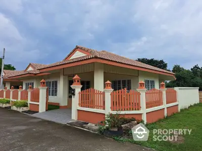 Charming single-story home with fenced yard and tiled roof in serene neighborhood.