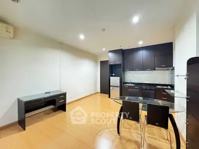 Modern kitchen with sleek cabinetry and dining area in open layout