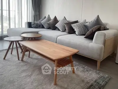 Stylish modern living room with cozy sofa and chic wooden coffee tables