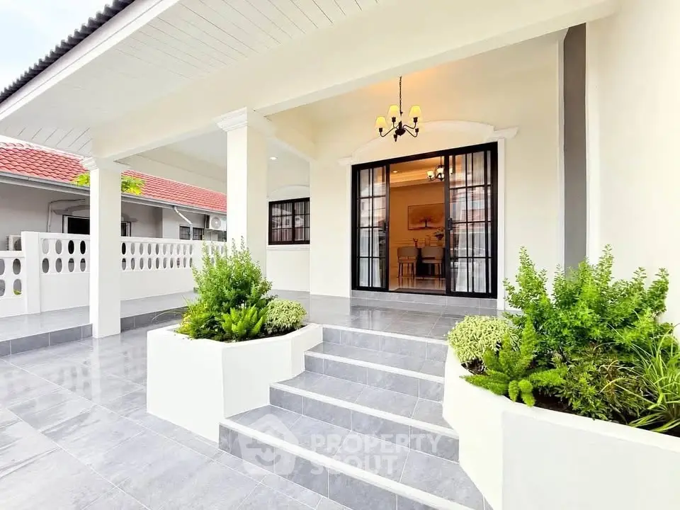 Charming modern home entrance with elegant steps and lush greenery