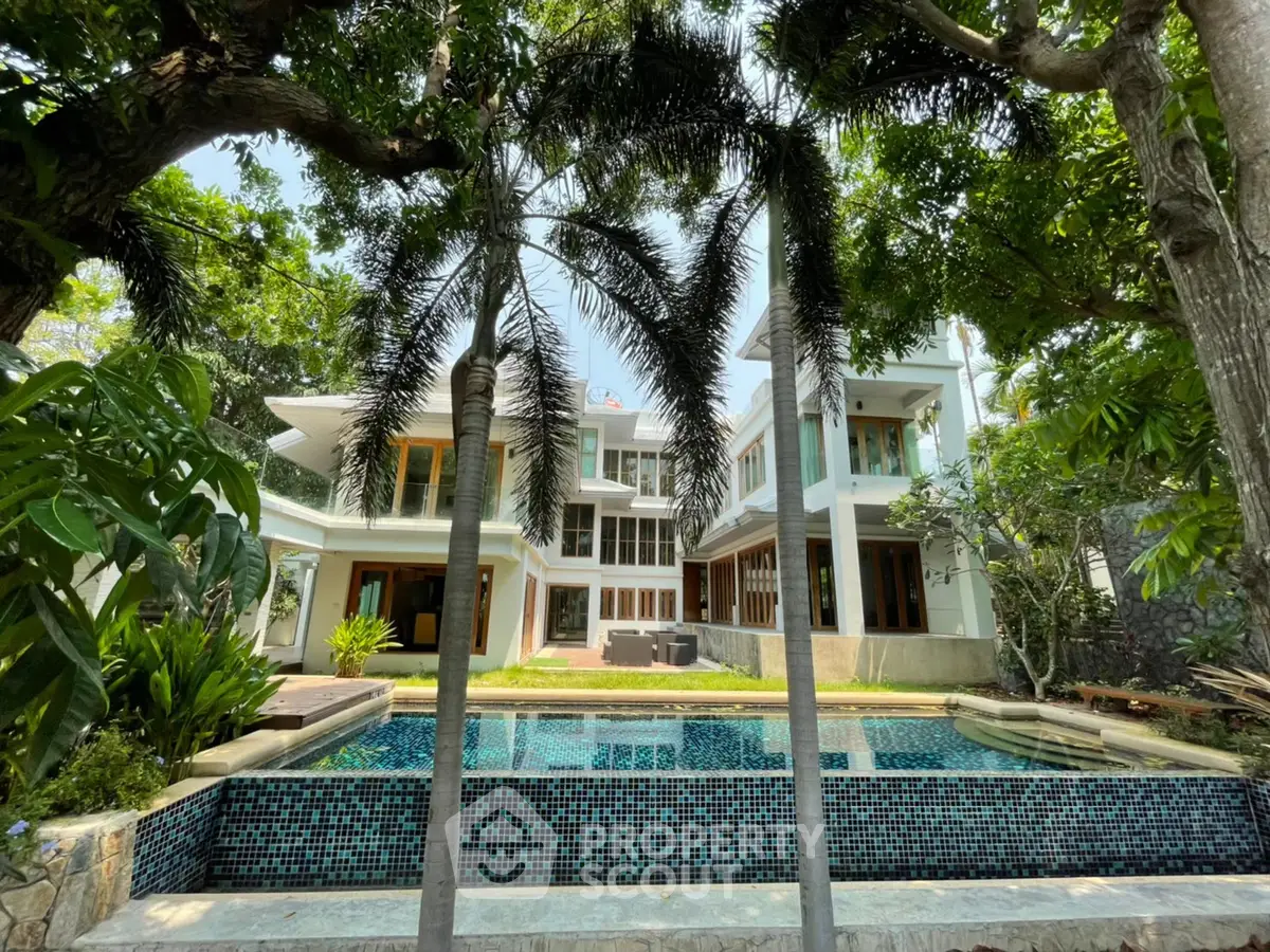 Luxurious modern villa with stunning pool and lush garden surroundings