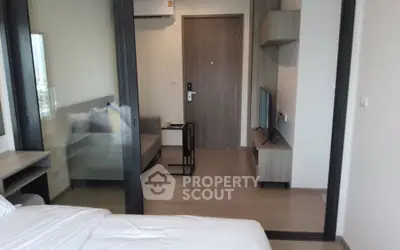 Modern apartment interior with sliding glass doors and sleek furniture design.