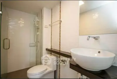 Modern bathroom with sleek fixtures and glass shower enclosure