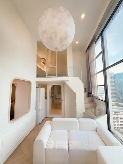 Stunning modern loft with high ceilings and large windows offering a breathtaking city view.