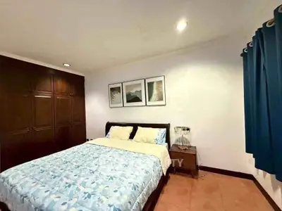 Cozy bedroom with elegant wooden wardrobe and stylish decor