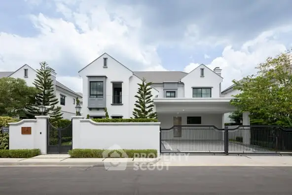 Elegant modern white house with spacious driveway and lush greenery