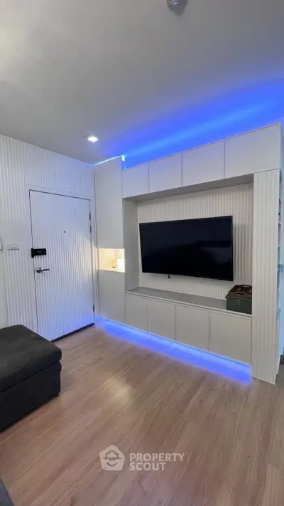 Modern living room with sleek TV setup and ambient lighting