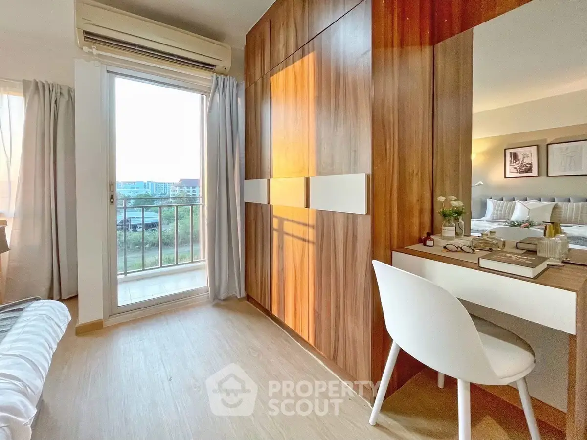 Modern bedroom with balcony access and stylish wood paneling, perfect for relaxation.