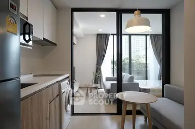 Modern open-plan kitchen and living room with sleek design and natural light.