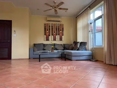 Spacious living room with modern decor and large windows for natural light.