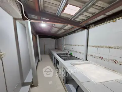 Spacious kitchen with tiled countertops and open layout in modern home