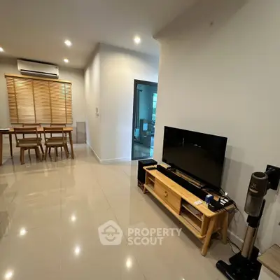 Spacious modern living room with sleek tile flooring and stylish dining area, perfect for contemporary living.