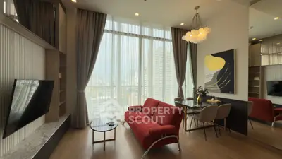 Stylish living room with modern decor and large windows offering city views.