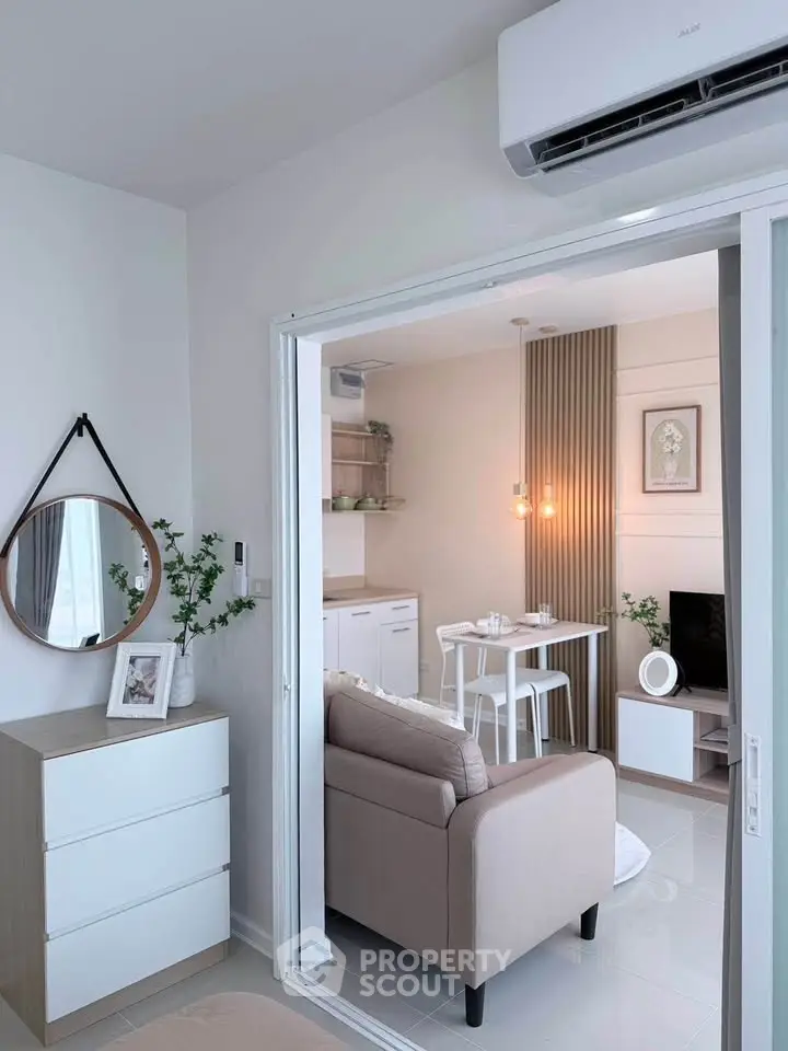 Modern living room with open layout, featuring stylish furniture and elegant decor in a cozy apartment.