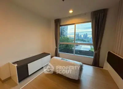 Spacious bedroom with city view and modern furnishings in urban apartment