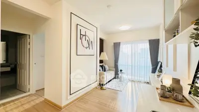Bright modern living room with stylish decor and large window, perfect for relaxation.